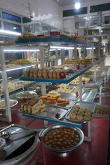 Varieties of sweets are organised on the trays inside a sweet shop