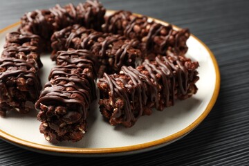Delicious chocolate puffed rice bars on dark gray wooden table, closeup