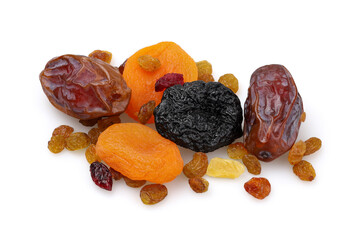 Dates, dried apricots, prunes, raisins scattered on a white background