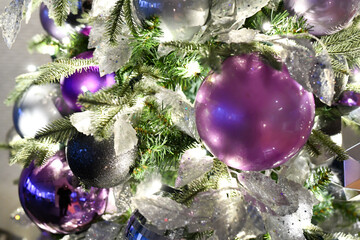 Christmas tree ornaments hanging on the branches