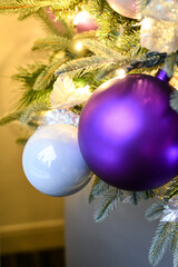 Christmas tree ornaments hanging on the branches