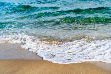 wave crashing on sandy beach