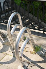 metal bicycle parking in business part of city or in park, gray colorful white-standing counter, concept of outdoor activities and cycling to work, sports