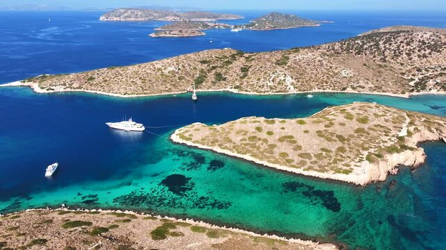 Aerial drone cinematic video of paradise island with crystal clear turquoise beaches and main seaside port of Arki or Arkoi, Dodecanese, Greece