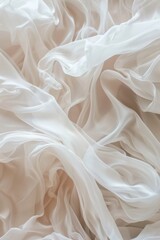 Fototapeta premium Elegant white silk fabric with soft waves and folds in gentle lighting