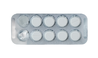 White round pills in blister pack laid on a flat surface