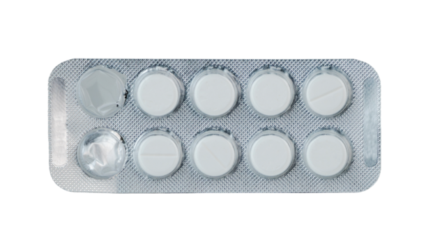 White round pills in blister pack laid on a flat surface