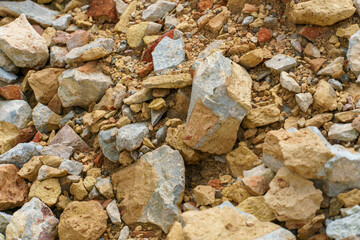 Piles of broken old bricks and other construction debris at the construction site. Construction background.