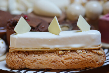 Eclair with white chocolate glaze decorated with white chocolate shavings