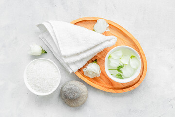 White cosmetics products with stones and white roses