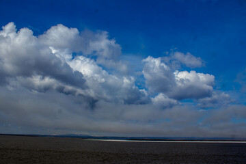 Dramatic clouds in the sky over a salt lake in winter