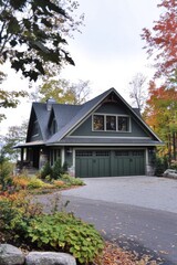 Beautiful green house surrounded by autumn foliage in a serene neighborhood with a stone driveway and well-maintained garden during early evening hours