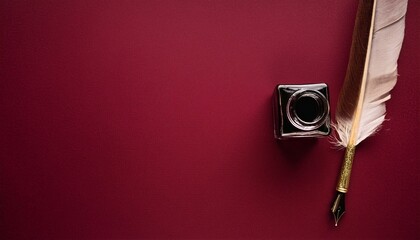 retro style image of an old quill pen and ink on a burgundy background captured from a top view perspective with space for copying