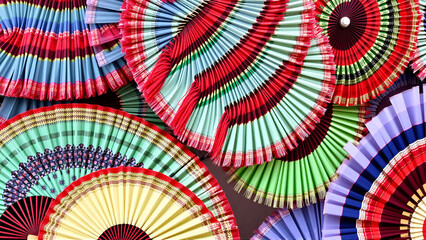 Display of colorful traditional spanish flamenco fans in Andalusia, Spain background