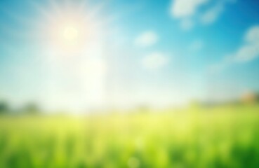Blurred spring meadow scene shows bright blue sky blending into vibrant green grass. Sunny day with soft light creates beautiful gradient effect. Abstract nature background suitable for various