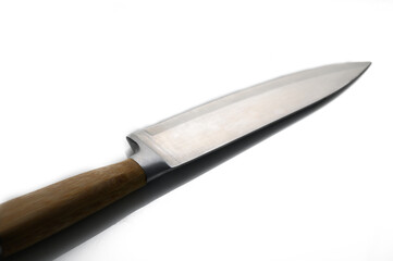 Sharp kitchen knife resting on a clean surface with a wooden handle showcasing craftsmanship and design