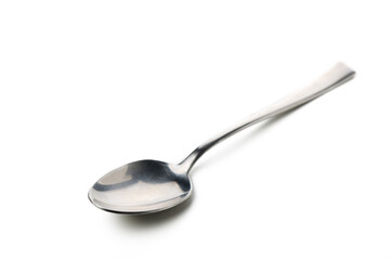 Elegant steel spoon resting on a smooth white surface awaiting its next culinary adventure