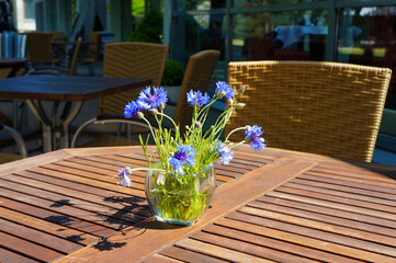 Posy of Cornflowers on a Table in a Street Cafe in Palanga, Lithuania.