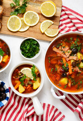 Solyanka. Russian traditional soup with smoked meats and pickles .style rustic