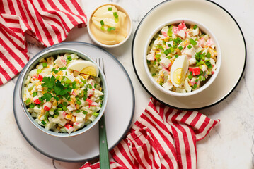 Traditional Russian salad with crab sticks, eggs and corn