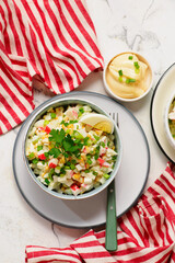 Traditional Russian salad with crab sticks, eggs and corn