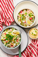 Traditional Russian salad with crab sticks, eggs and corn