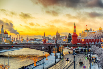 Fototapeta premium Beautiful sunset over the Moscow River, Cathedral of Christ the Saviour and embankment of the Kremlin. Winter colorful sunset in Moscow, Russia.