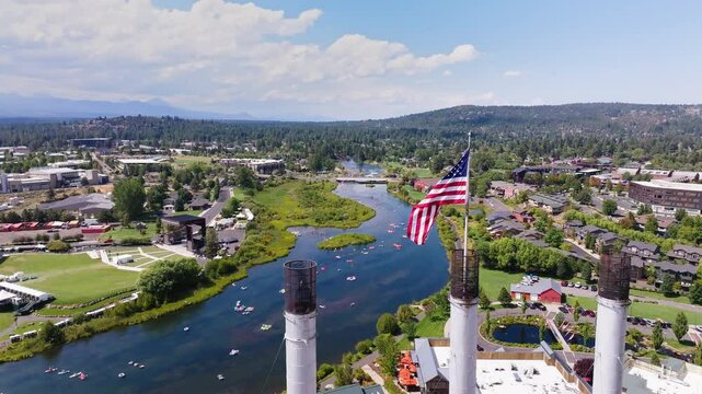 Patriotic Flow: Aerial Drone Shot of the Deschutes River with Rafting and American Flag in Bend, Oregon