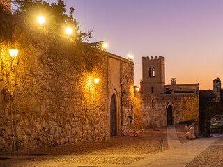 Photo of a cobblestone street in the old part of the city of Zamora, San Salvador cathedral in the background. Streetlight lighting. Zamora. Castilla y León. Spain.
