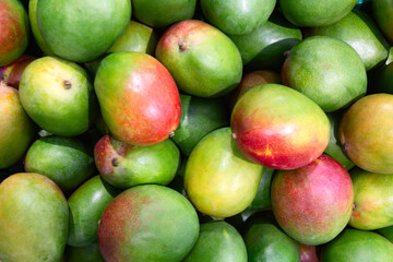 Fresh mango fruits as a food background