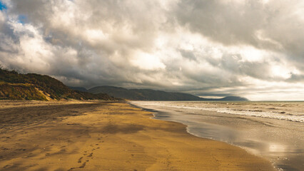 stunning warm sunset on a sea ocean sun water dramatic skies kapiti new zealand 