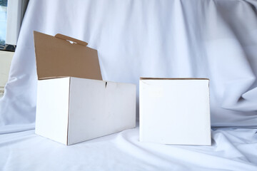 Simple White Cardboard Box on Fabric Background for Mockup and Packaging Design Projects