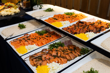 platters of smoked salmon, chopped egg salad and garnishes being served on white platters at bar mitzvah brunch buffet
