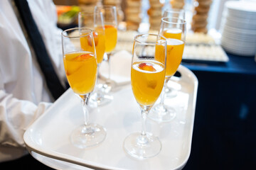 platter of tasty mango brunch cocktails being served on white tray
