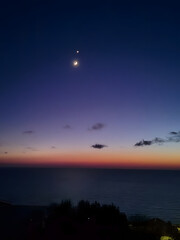 Crescent Moon and Venus Conjunction Over the Sea at Nigh