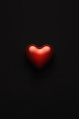 A vibrant red heart glows against a deep black backdrop, symbolizing love's passion and intensity on Valentine's Day.
