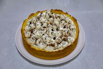Traditional banoffee cake with banana and caramel sauce filling sprinkled with grated dark chocolate and coffee . English traditional pie