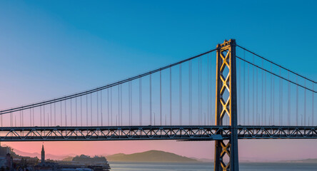 Cruise ship docked near panoramic San Francisco financial skyline near Oakland Bay Bridge.