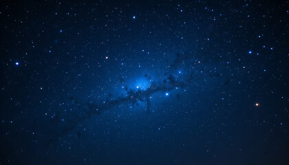 Fototapeta premium A deep blue night sky filled with countless glowing stars scattered across the vast darkness of space. 