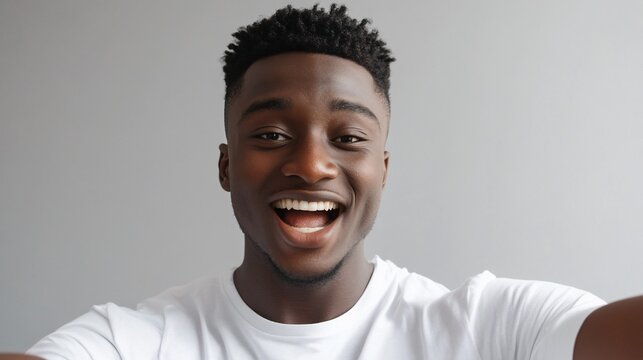 Happy young Black man smiling broadly at camera.
