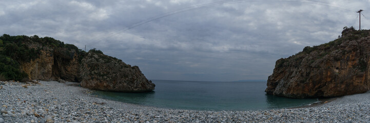 Panoramic view of famous rocky beach Foneas near Kardamyli village with turquoise colored water in spring time, Messinia, Peloponnese, Greece