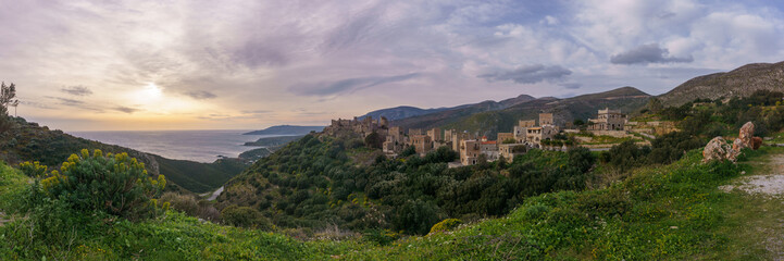 Panorama of costal view of historical town with the famous old residential towers on the peninsula Mani during sunset, Vathia, Peloponnese, Greece