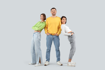 Fototapeta premium Young people in jeans on light background