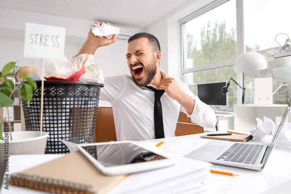 Sticker Stressed businessman with crumpled paper at table in office