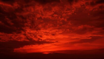 Fototapeta premium Fiery Red Sunset Sky with Dramatic Cloud Formations and Intense Warm Glow, Perfect for Atmospheric Nature Art or Background Concepts