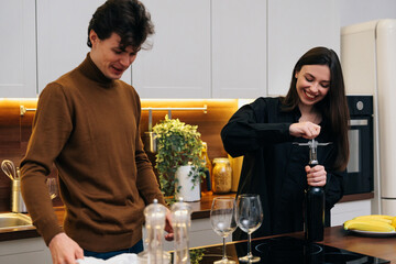 Young couple enjoying time together in kitchen while preparing dinner