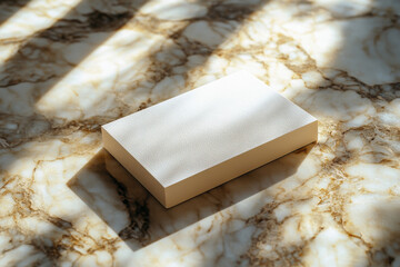 Cream-colored box sits on a marble surface bathed in sunlight. The shadows create a minimalist, elegant mood.