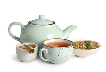 Cup and teapot of hot buckwheat tea with honey on white background