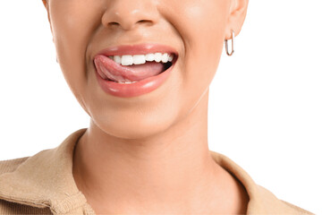Obraz premium Young woman showing tongue on white background, closeup