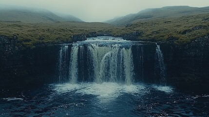 Fototapeta premium Misty mountain waterfall cascading into a tranquil pool.